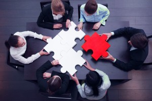 business team solving puzzle concept